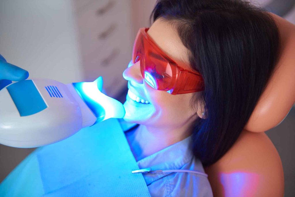 women getting tooth whitening treatment